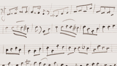 Old sheet of music score with hand-written notes